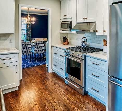 small kitchen with white cabinets and refinished hardwood floors