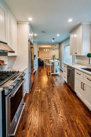 refinished hardwood floors custom stained in remodeled galley kitchen