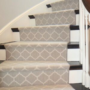 Curved ivory stair runner with classic geometric pattern.png