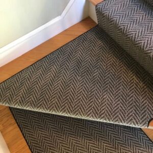 Elbow stair case with herringbone stair runner and waterfall installation.png