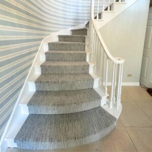 Grey stair runner with beautiful wall paper.png