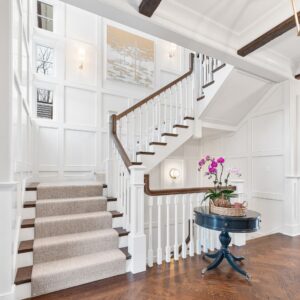 Neutral wool stair runner on white elbow staircase.png
