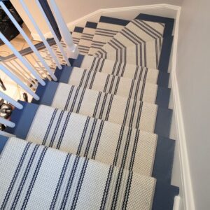 Striped ivory and blue stair runner with painted stairs and elbow.png